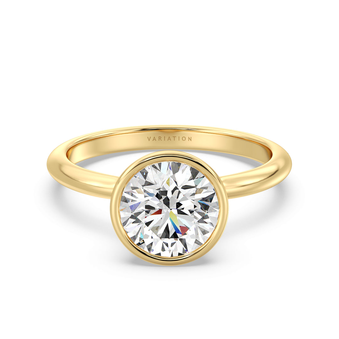 Elegant Round Cut Bezel Set Lab-Grown Diamond Solitaire Ring in 18K Yellow Gold. Showcases a stunning round cut diamond set in a sleek bezel design