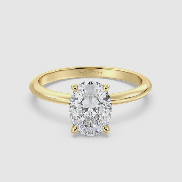 Video of the Timeless 4-Claw Oval Lab-Grown Diamond Solitaire Engagement Ring in 18K Yellow Gold, rotating to display the sparkling oval-cut diamond and the luxurious gold band from various angles.