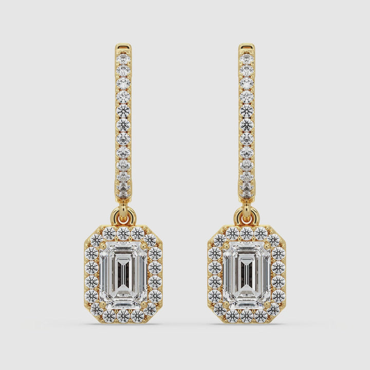 Video showcasing Elegant Emerald Cut Lab-Grown Diamond Minimalist Halo Hoop Earrings in Yellow Gold, highlighting the sparkle of 3.90 carats of lab-grown diamonds set in luxurious 18K gold. Watch as the exquisite emerald cut and round cut diamonds dazzle from every angle, perfect for any occasion.