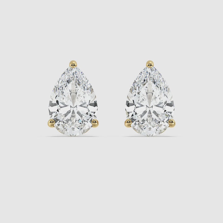 Video showcasing Timeless Pear Shaped Lab-Created Diamond Stud Earrings in Yellow Gold. Featuring close-up views of the dazzling EF/VS lab-grown diamonds set in luxurious 18K yellow gold. Perfect for any occasion, highlighting their elegant design and brilliant sparkle.